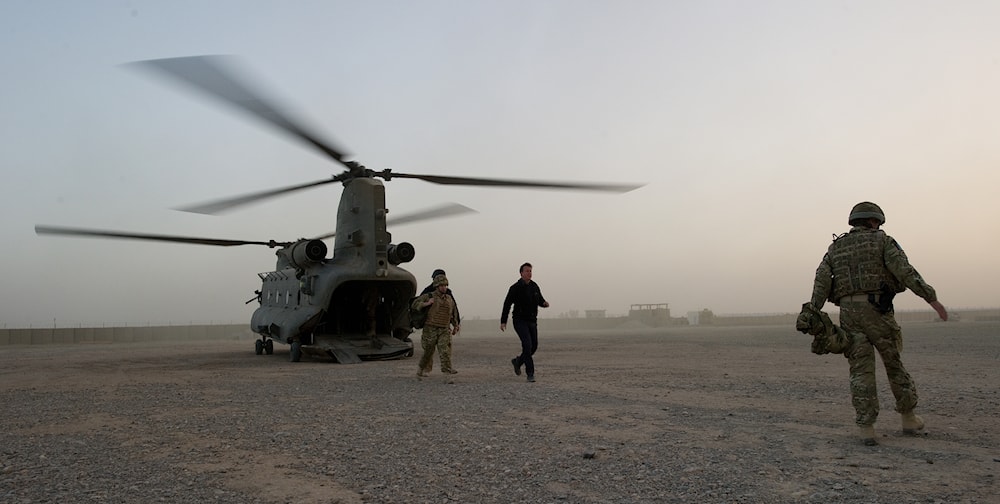 British Prime Minister David Cameron, centre, arrives at the Helmand Police Training Centre in Afghanistan Monday Dec. 6, 2010. (AP)