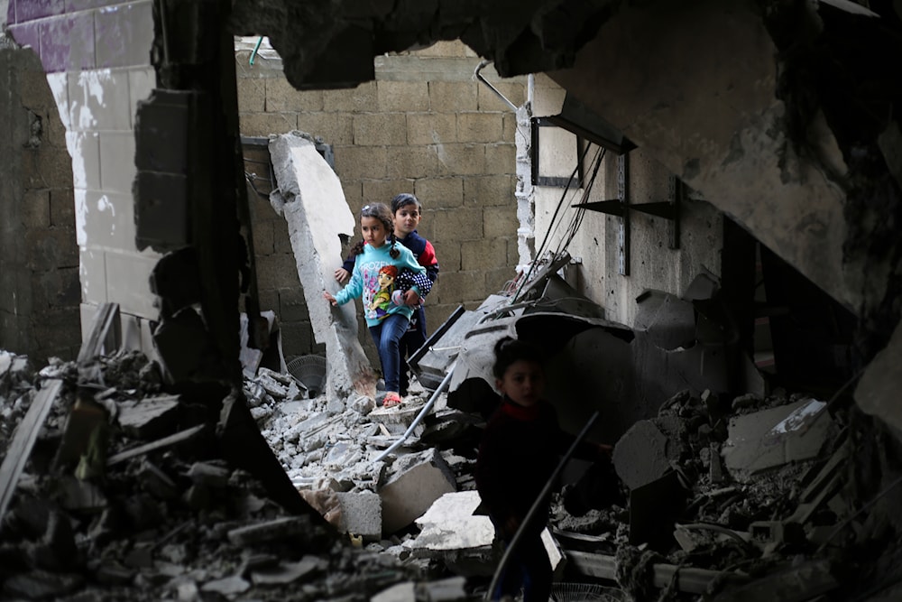 Palestinian children walk after an Israeli strike on residential buildings in Rafah, Gaza Strip, on Thursday, Dec. 14, 2023. (AP)