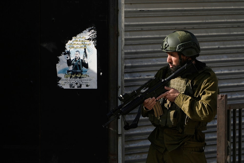 Israeli occupation forces are seen during an army operation, in the Jenin refugee camp, West Bank, Tuesday, Dec. 12, 2023. (AP)