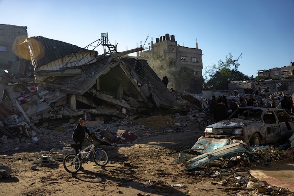 Palestinians search for bodies and survivors in the rubble of a residential building destroyed in an Israeli airstrike, in Rafah, southern Gaza Strip, Friday, Dec. 15, 2023 (AP Photo/Fatima Shbair)