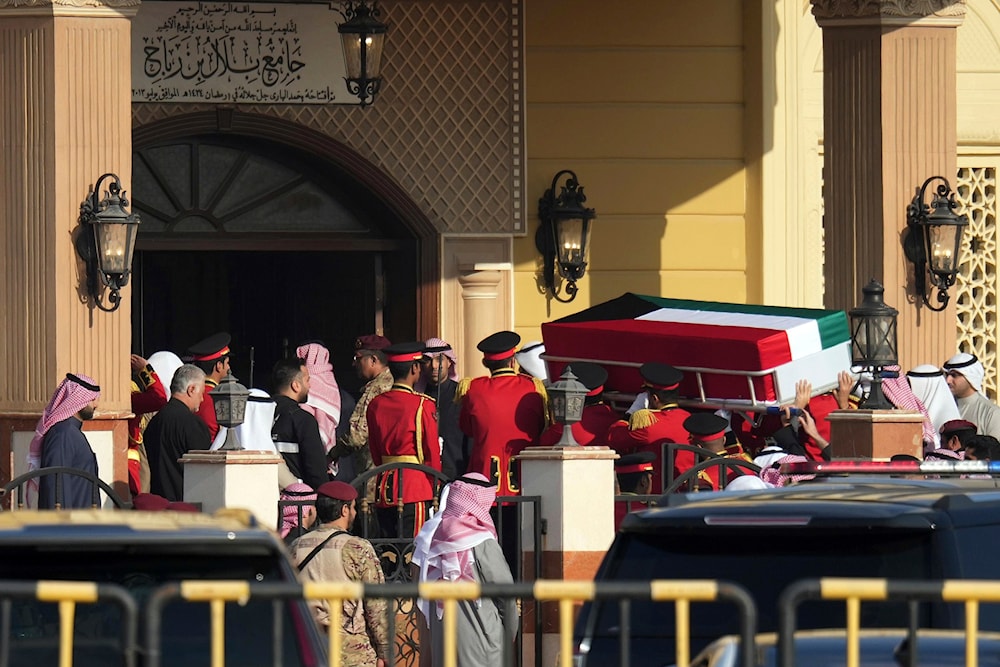 The coffin of the Emir of Kuwait Sheikh Nawaf Al Ahmad Al Sabah is being carried during his funeral at the Bilal bin Rabah Mosque in Kuwait, Sunday, Dec. 17, 2023. (AP)