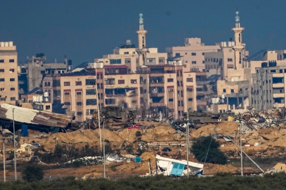 Israeli military vehicles operate inside Gaza Strip, as seen from southern Palestine, Sunday, Dec. 17, 2023. (AP Photo/Ariel Schalit)