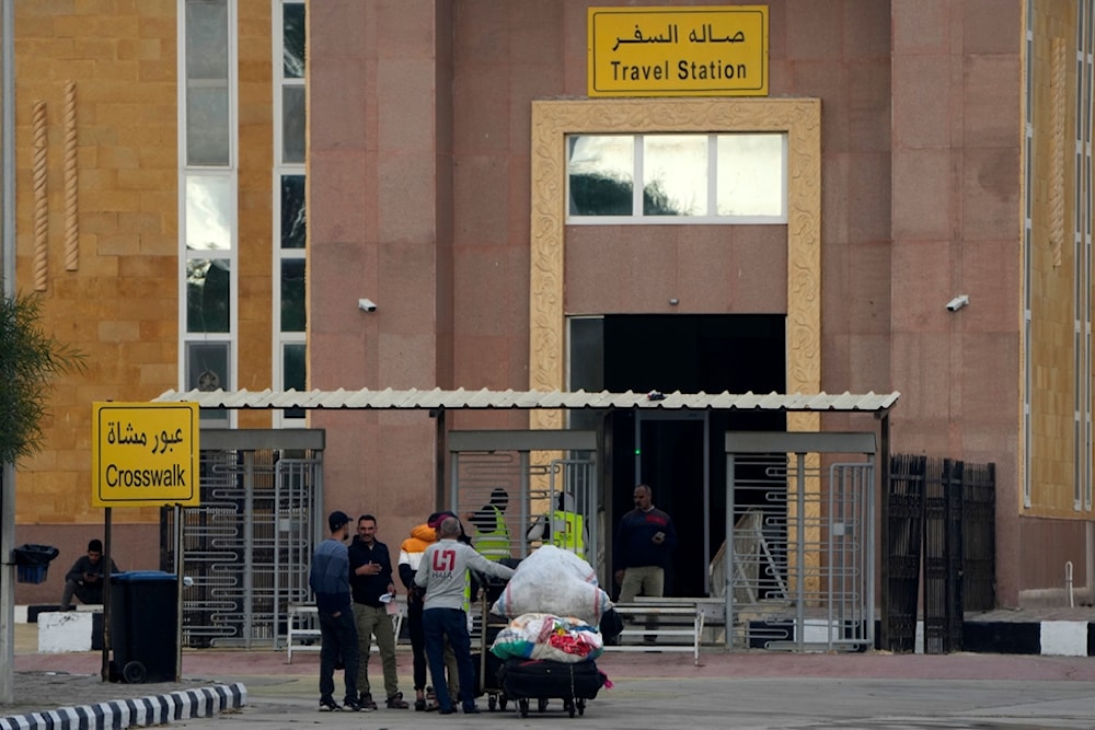 Palestinians stranded in Egypt cross Rafah crossing to the Gaza Strip at Rafah, Egypt, as a temporary ceasefire went into effect, Monday, Nov. 27, 2023 (AP Photo/Amr Nabil)