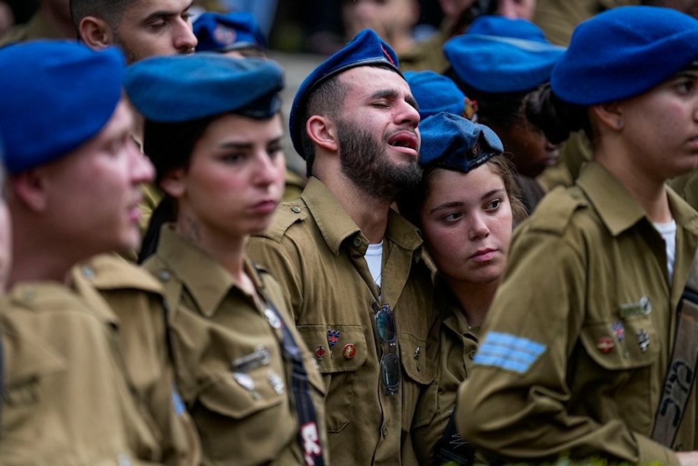Israeli soldiers mourn during the funeral of Israeli soldier Corporal Avraham Fetena in Haifa, northern occupied Palestine, November 17, 2023 (AP)