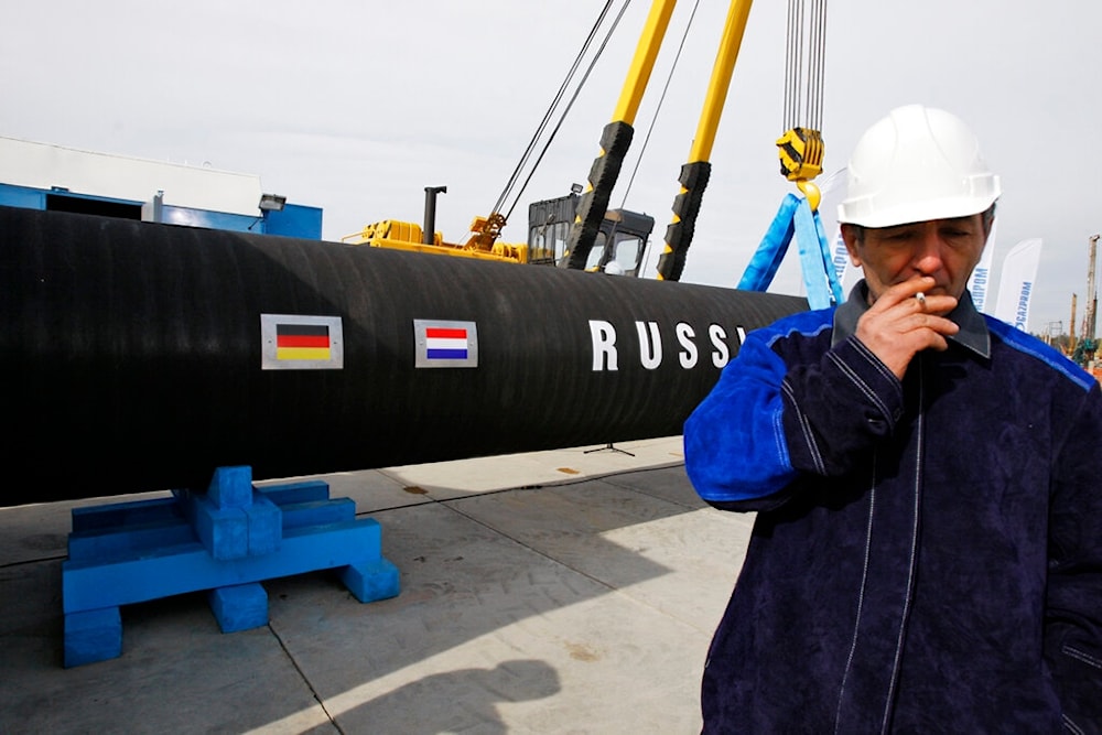 A Russian construction worker smokes in Portovaya Bay some 170 kms (106 miles) north-west from St. Petersburg, Russia, on April 9, 2010, during a ceremony marking the start of Nord Stream pipeline construction (AP)