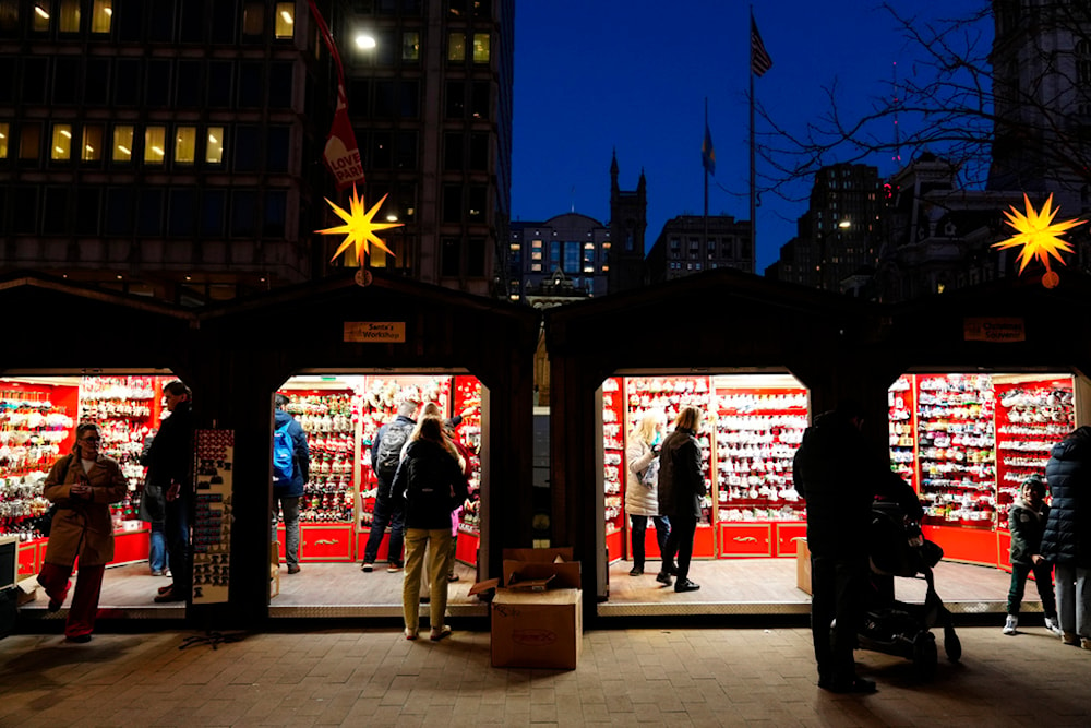 Shoppers visit the Christmas Village in Philadelphia, Wednesday, Dec. 13, 2023 (AP Photo/Matt Rourke)