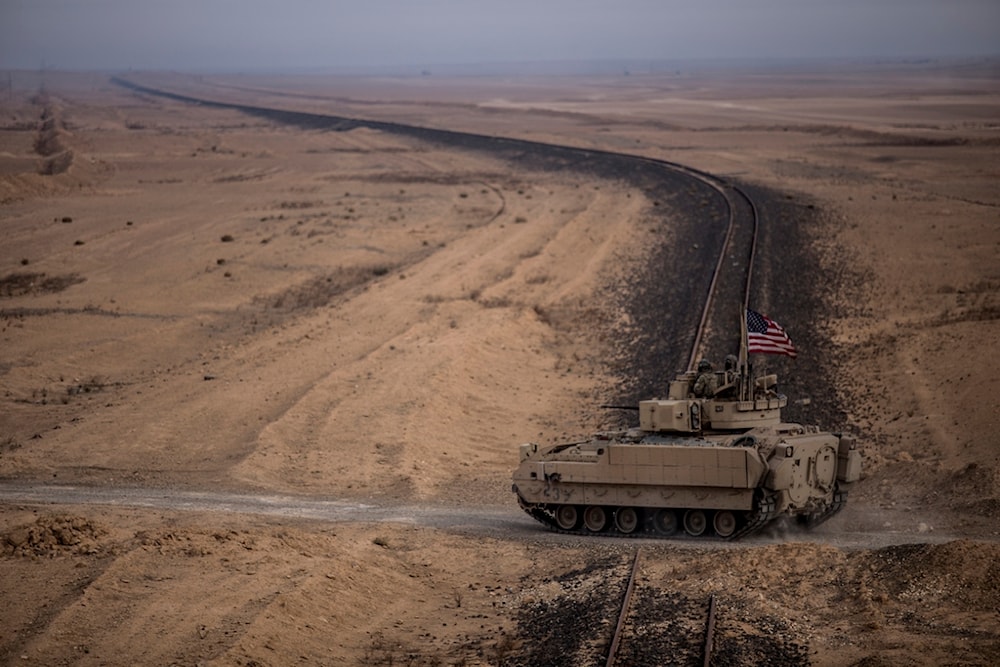 American soldiers drive a Bradley fighting vehicle during a joint exercise with Syrian Democratic Forces in the countryside of Deir Ezzor in northeastern Syria, Wednesday, Dec. 8, 2021 (AP)