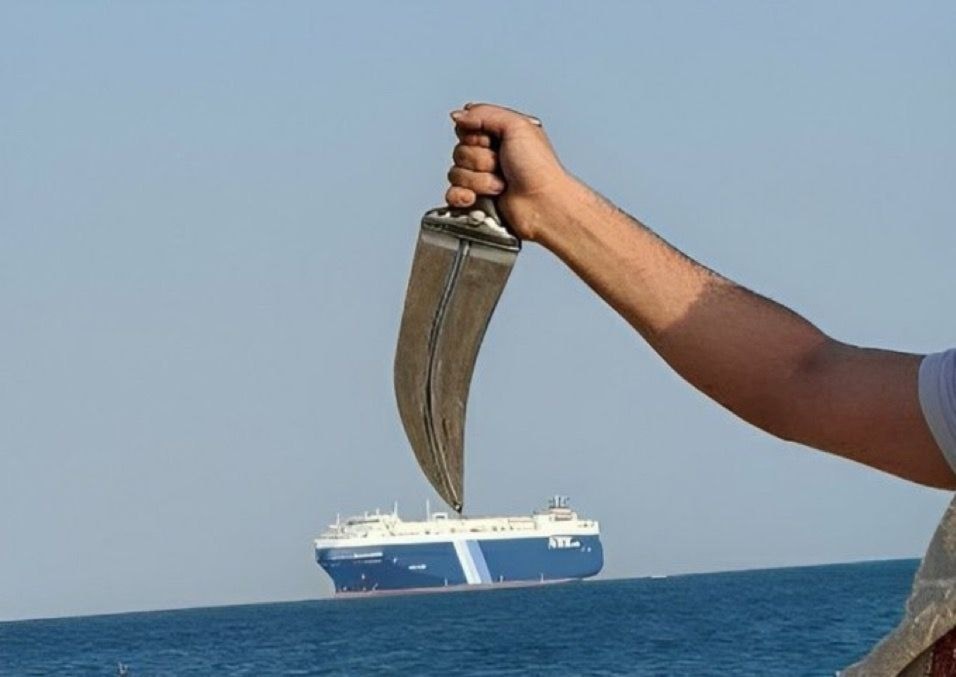 Yemeni fighter brandishing a traditional Yemeni dagger above a cargo ship -undated- (social media)