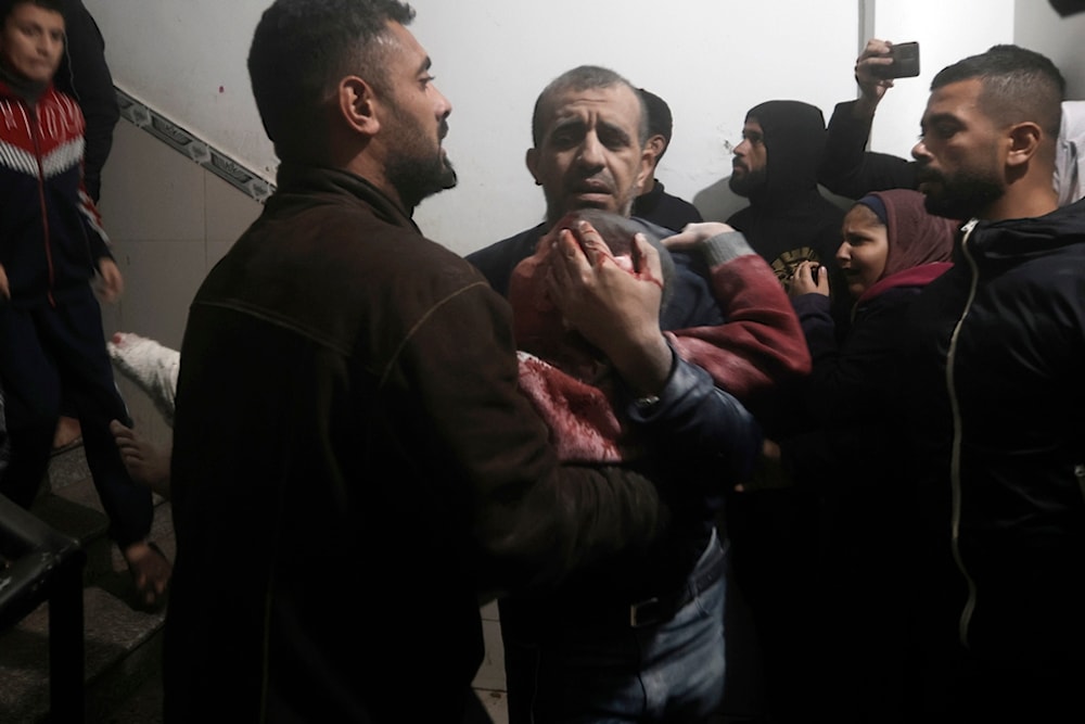 Palestinians evacuate a wounded boy following Israeli strikes on the maternity ward at Nasser Hospital in the town of Khan Younis, southern Gaza Strip, Sunday, Dec. 17, 2023. (AP)