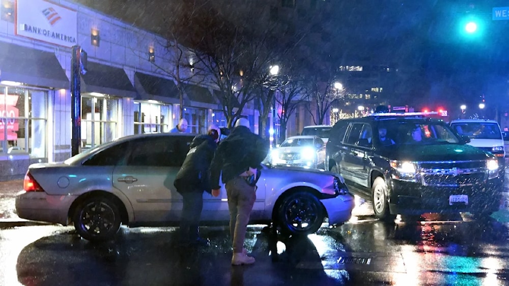 Agents surrounding a car that hit a motorcade vehicle as President Biden was leaving his campaign headquarters in Wilmington, Del., on December 17. (AFP via Getty Images)