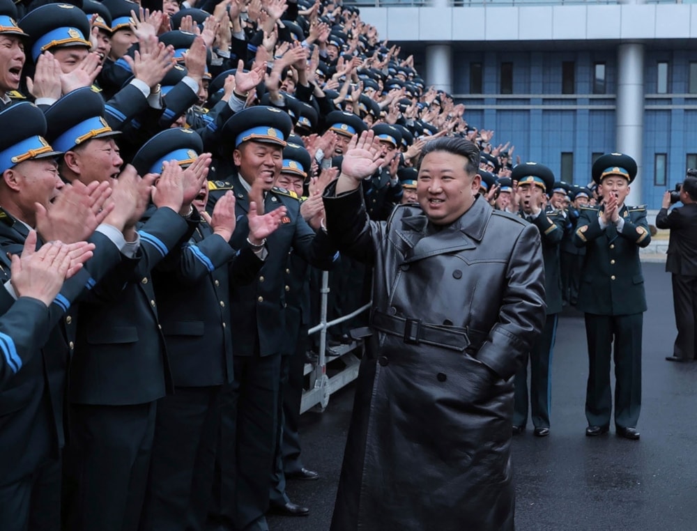 Kim Jong Un greets workers at the National Aerospace Techonology Administration (NATA) following successful launch of a reconnaissance satellite on November 23, 2023. (AP)