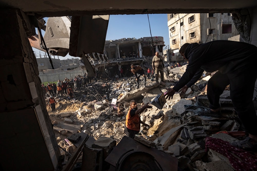 Palestinians search for bodies and survivors in the rubble of a residential building destroyed in an Israeli airstrike, in Rafah, southern Gaza Strip, Tuesday, Dec. 19, 2023 (AP Photo/Fatima Shbair)