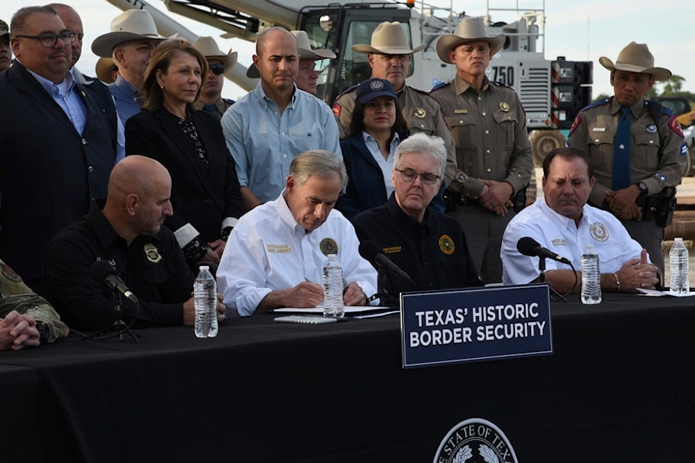Gov. Greg Abbott signs three bills into law at a border wall construction site in Brownsville, Texas on Monday, Dec. 18, 2023, that will broaden his border security plans and add funding for more infrastructure to deter illegal immigration. (AP)