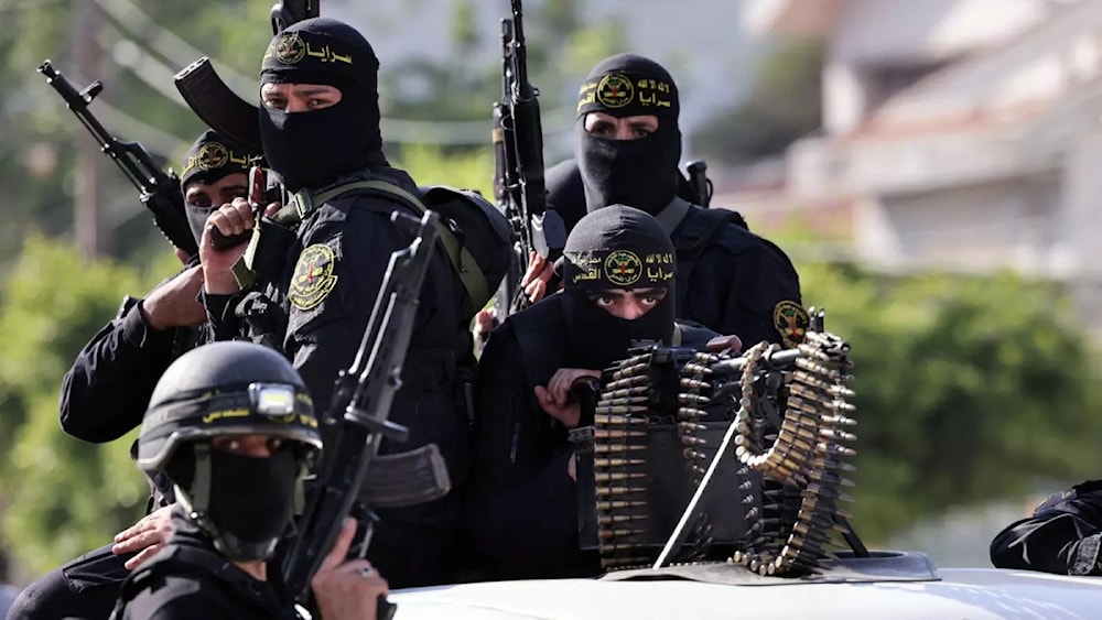 Fighters with the Palestinian Islamic Jihad movement parade with their weapons in the streets of Gaza City during a rally on May 29, 2021. (AFP)
