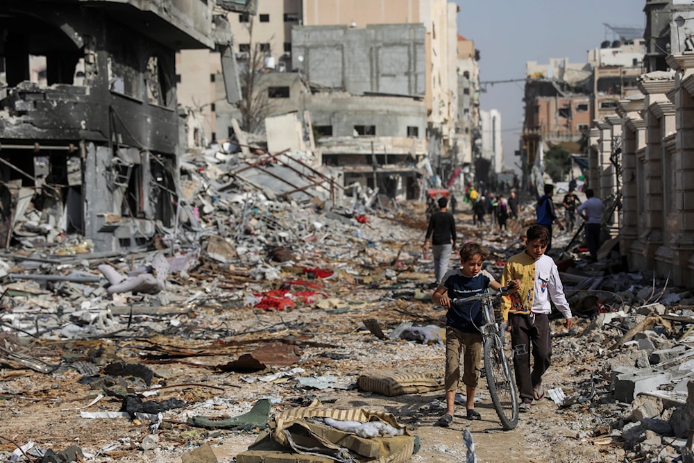 Palestinians walk through destruction in Gaza City on Friday, Nov. 24, 2023, as the temporary ceasefire takes effect. (AP)