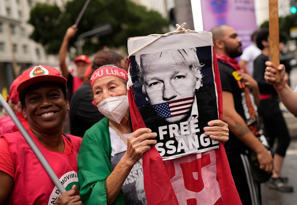 A demonstrator with a sign of Julian Assange protests his extradition to the U.S. in Rio de Janeiro, Brazil, Thursday, Sept. 7, 2023. (AP)