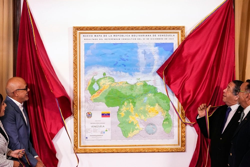 National Assembly President Jorge Rodriguez, and Chairman of the Special Commission for the Defense of Guyana Essequibo Hermann Escarra, unveil Venezuela's new map that includes the Essequibo territory, in Caracas, Venezuela, Friday, Dec. 8, 2023. (AP)