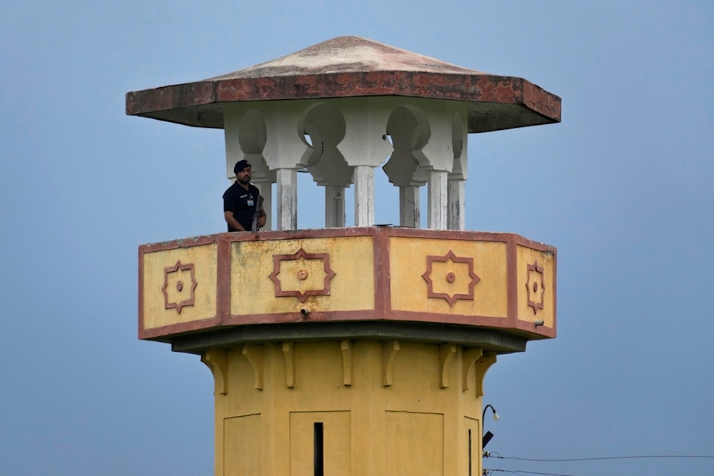 A police officer stands guard on a watch tower of district prison Attock, where Pakistan's former Prime Minister Imran Khan in-prison after his conviction, in Attock, Pakistan, Sunday, Aug. 6, 2023. 