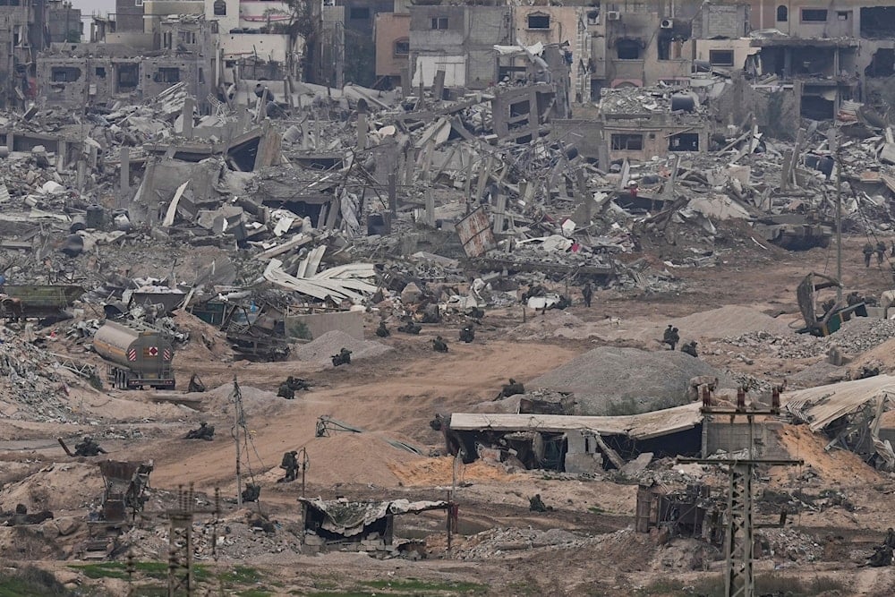 Israeli occupation troops take positions in the Gaza Strip as seen from southern occupied Palestine, Thursday, Dec. 21, 2023 ( AP Photo)