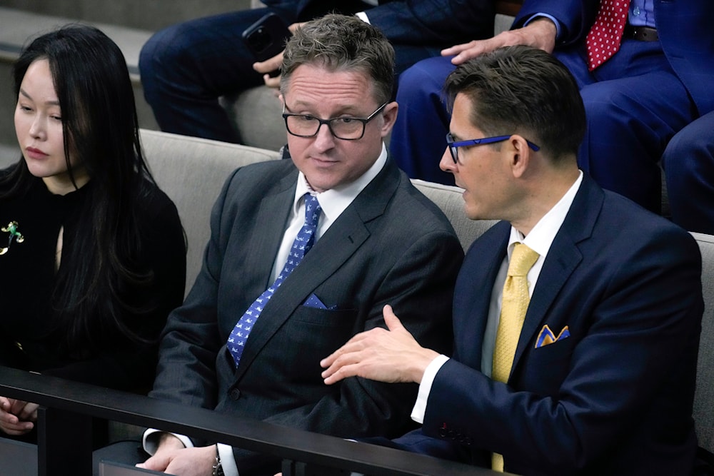 Canadians Michael Kovrig, right, and Michael Spavor, second from left, talk before an address from President Joe Biden in the Canadian House of Commons on March 24, 2023, in Ottawa, Canada. (AP)