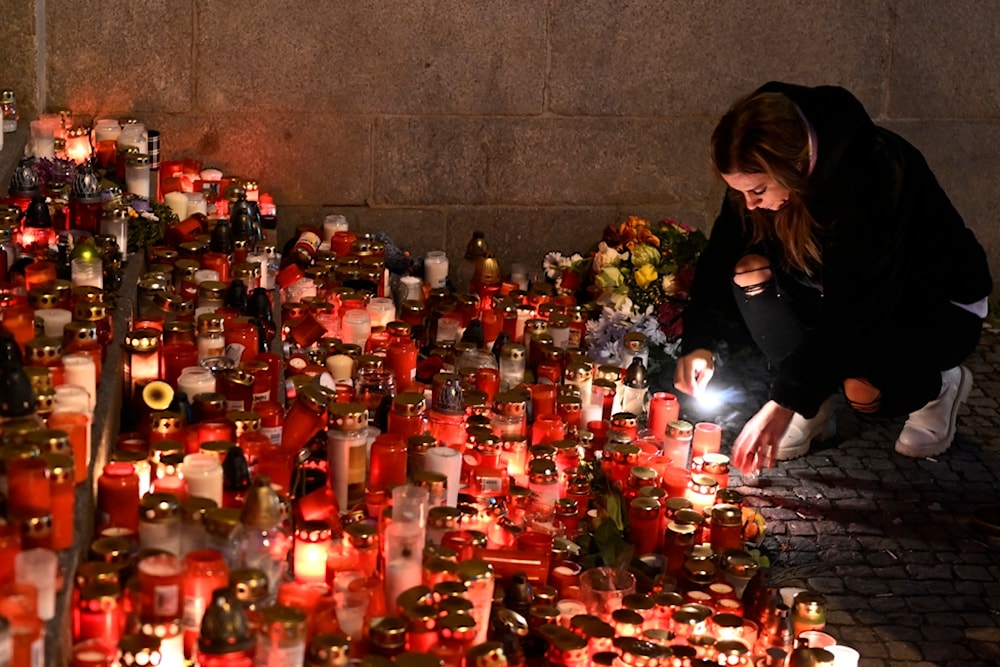 Mourners bring flowers and candles outside the building of Philosophical Faculty of Charles University in downtown Prague, Czech Republic, Saturday, Dec. 23, 2023. (AP)