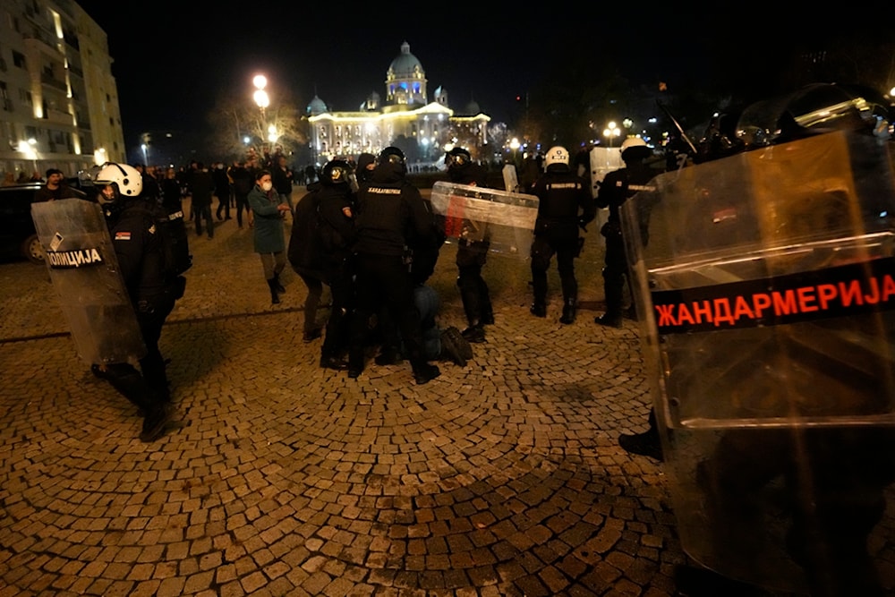 Protesters clash with gendarme in Belgrade, Serbia, Sunday, Dec. 24, 2023. (AP)