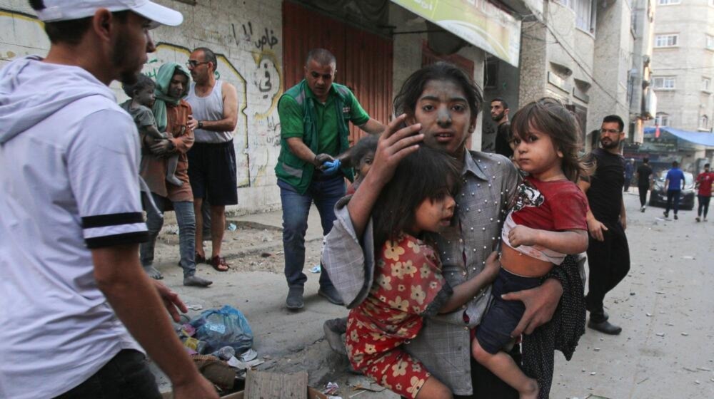 A child flee with her siblings after an Israeli airstrike in Gaza City. (AFP via Getty Images)