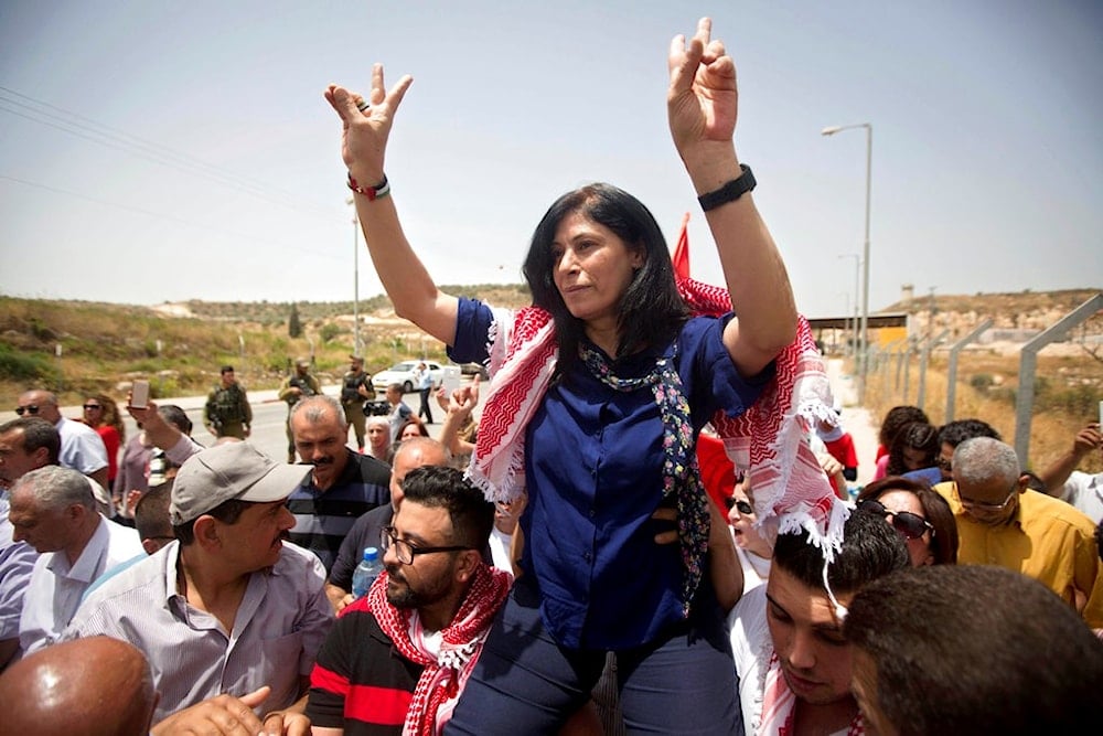 In this June 3, 2016 file photo, Palestinian PFLP leader and liberated detainee Khalida Jarrar is greeted by supporters after her release from an Israeli prison at the Jabara checkpoint near the West Bank town of Tulkarem, occupied Palestine. (AP)