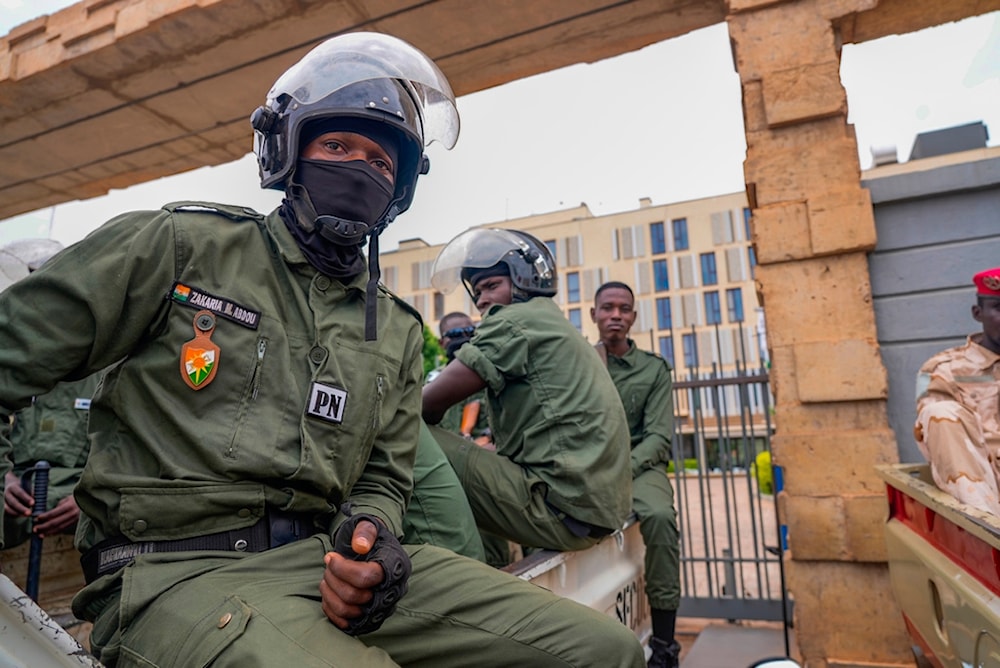 Nigerien police officers sit outside the customs offices in Niamey, Niger, on Aug. 21, 2023. (AP)