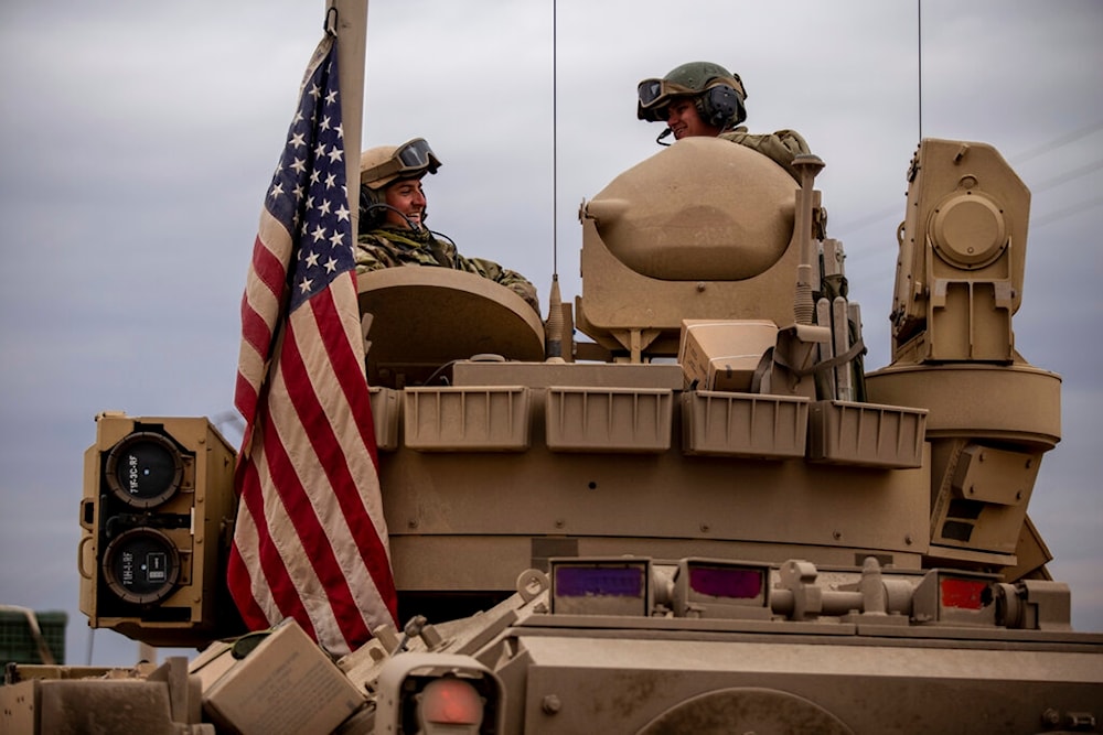 American occupation forces sit in a fighting vehicle in al-Hasakah, Syria, February 8, 2022 (AP)