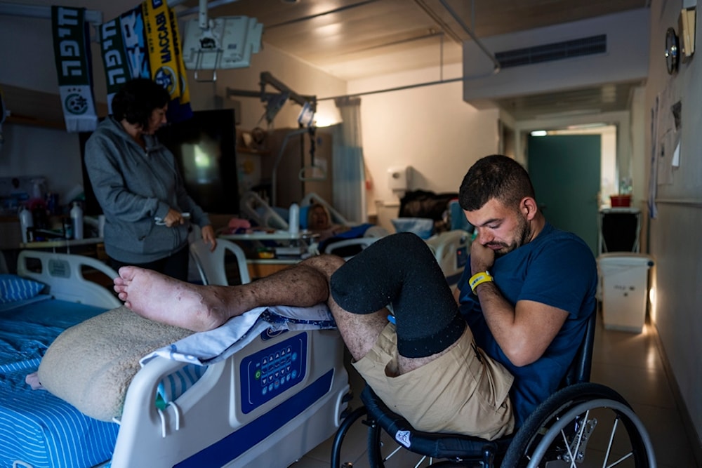 Israeli soldier Jonathan Ben Hamou, 22, wounded in the war with Hamas, sits in his room at Sheba hospital's rehabilitation division, Monday, Dec. 18, 2023 (AP)