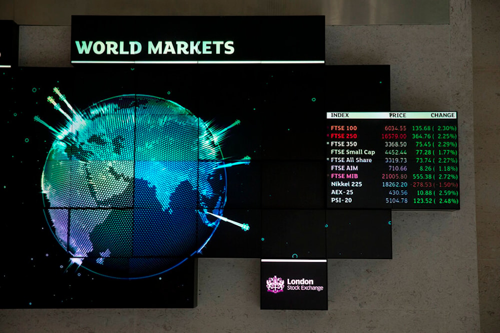 Financial market information is displayed inside the London Stock Exchange in the City of London, Tuesday, Aug. 25, 2015. (AP)