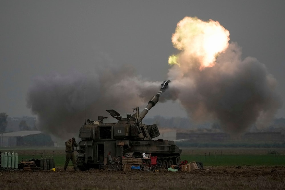 An Israeli mobile artillery unit fires a shell from southern occupied Palestine towards the Gaza Strip on Thursday, Dec. 14, 2023 (AP Photo)