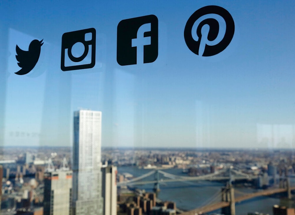 Icons for Twitter, Instagram, Facebook, and Pinterest are displayed on a window, New York, Wednesday, Jan. 13, 2016 (AP)