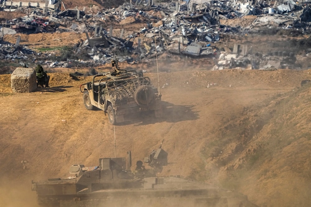 Israeli soldiers take up positions near the Gaza Strip envelope, in southern occupied Palestine, December 29, 2023 (AP)
