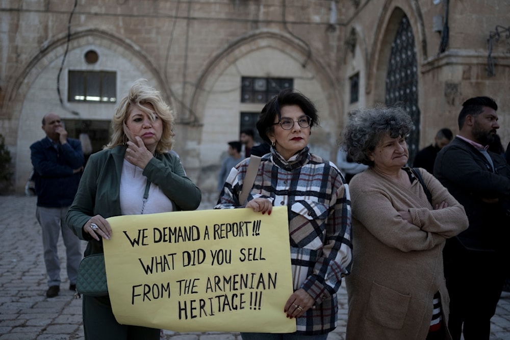 Members of the Armenian community protest a contentious deal to hand over a large section of the Armenian Quarter in the occupied Old City of al-Quds, occupied Palestine, May 19, 2023. (AP)