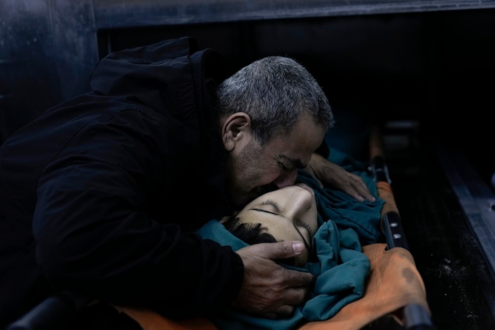 A relative mourns 15-year-old Basil Abu Al-Wafa, who was killed during a raid by the Israeli occupation forces on Jenin refugee camp in the West Bank, November 29, 2023 (AP)