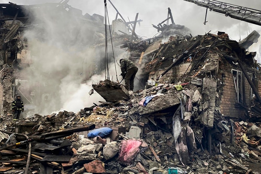 In this photo provided by Ihor Moroz, Head of the Donetsk Regional Military Administration, rescuers work at the scene of a building damaged by shelling, in Novogrodivka, Donetsk People's Republic, November 30, 2023 (AP)