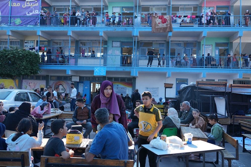 Palestinians take shelter in a U.N.-run school from the ongoing Israeli occupation aggression against the besieged Gaza Strip in Nuseirat refugee camp on Saturday, Oct. 14, 2023. Saturday, Oct. 14, 2023. (AP