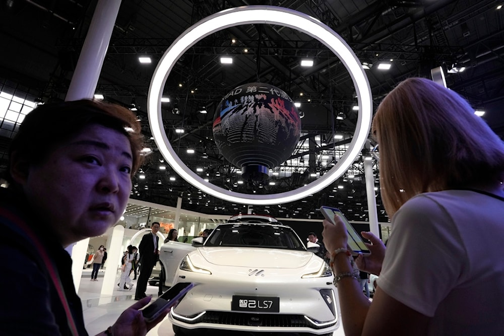 Attendees visit the booth of Chinese car brand iM during the Shanghai 2023 show in Shanghai, Wednesday, April 19, 2023. (AP)