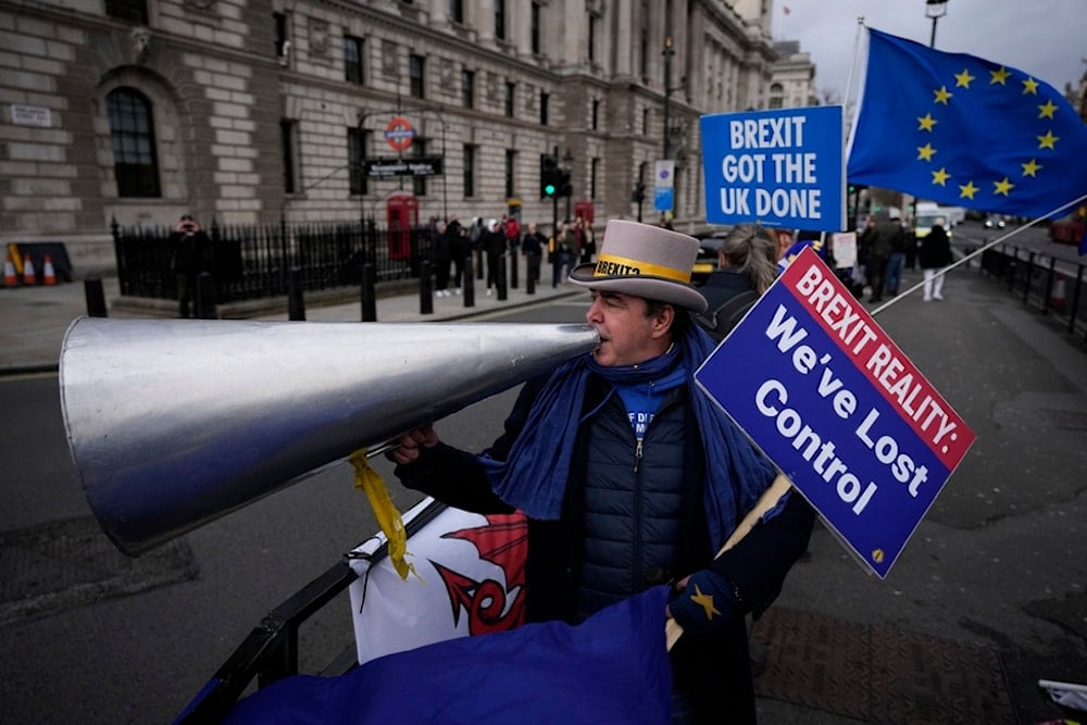 Anti-Brexit protester Steve Bray demonstrates on the edge of Parliament Square across the street from the Houses of Parliament, in London, Wednesday, Dec. 8, 2021. (AP)