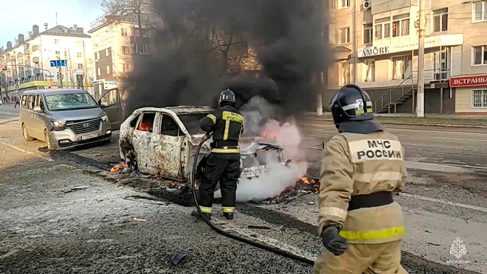 In this photo taken from video released by Russia Emergency Situations Ministry telegram channel on Saturday, Dec. 30, 2023, Firefighters extinguish burning cars after shelling in Belgorod, Russia. (AP)