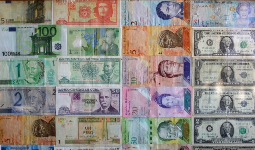 Bank notes from various countries are displayed on the wall of a small beverage shop Friday, Dec. 19, 2014. (AP)