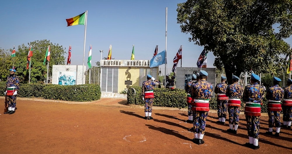 U.N. MINUSMA troops from Bangladesh hoist down the U.N flag for the last time at a departure ceremony held in Bamako, Mali, Monday, Dec. 11, 2023. (AP)