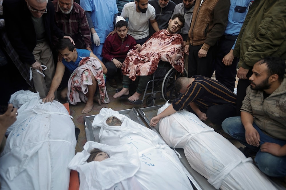 Palestinians mourn over the bodies of their relatives were killed in Israeli bombardments, at the Nasser hospital in Khan Younis refugee camp, southern Gaza Strip, Monday, Dec. 4, 2023. (AP)