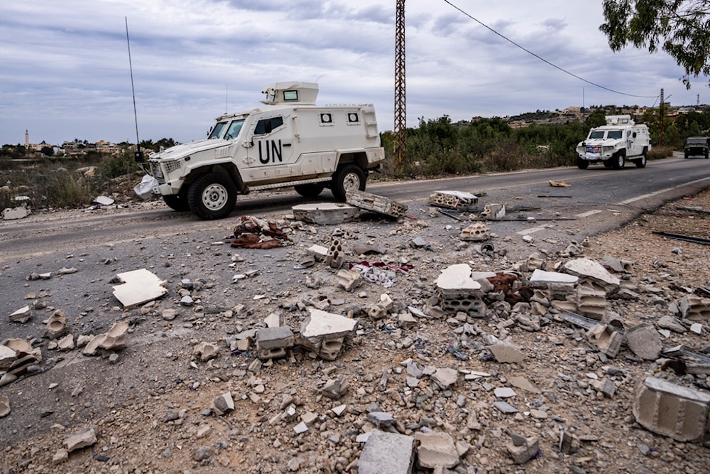 UN peacekeepers patrol next to a damaged house in the southern village of Marwahin, Lebanon, November 25, 2023 (AP)