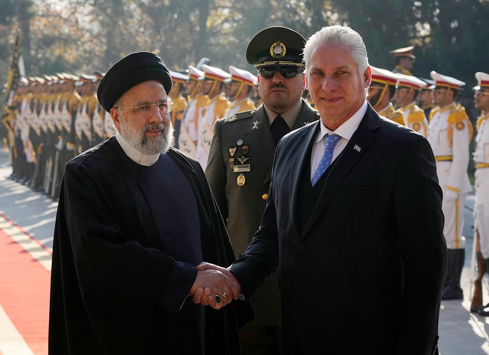 Cuban President Miguel Díaz-Canel, right, is welcomed by his Iranian counterpart Ebrahim Raisi during his official welcoming ceremony at the Saadabad Palace in Tehran, Iran, Dec. 4, 2023. (AP)