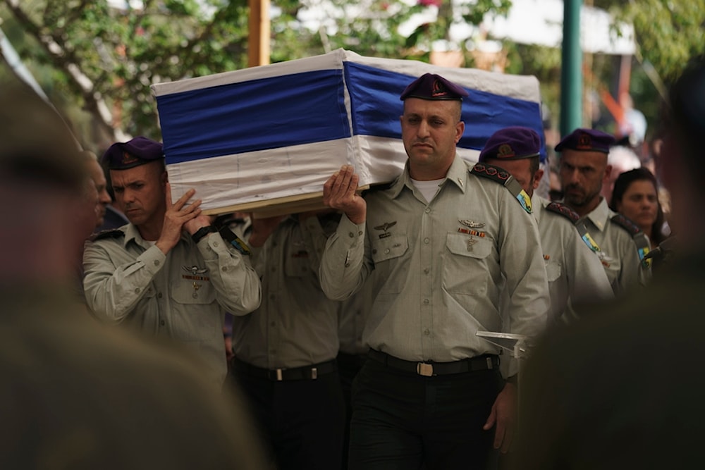 Israeli occupation forces carry the coffin of Col. Asaf Hamami during his funeral at the Kiryat Shaul military cemetery, in 'Tel Aviv', occupied Palestine, December 4, 2023