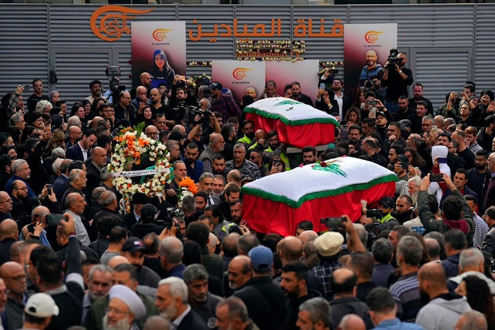 Mourners carry the coffins of the two journalists of pan-Arab TV network Al-Mayadeen who were killed by an Israeli strike, at the station's headquarters, in Beirut, Lebanon, Wednesday, Nov. 22, 2023 (AP)