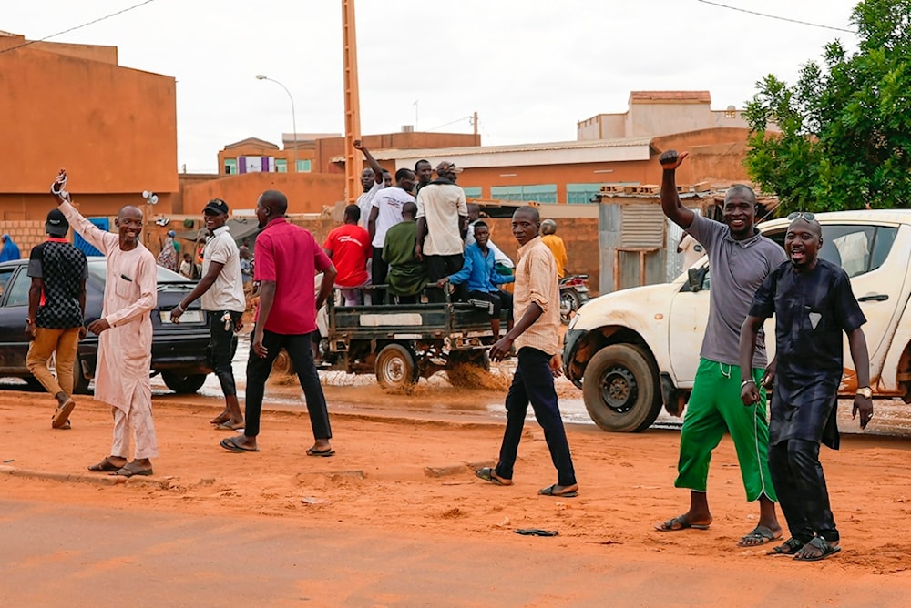 Nigerien men gather for an anti-French protest in Niamey, Niger, Friday, Aug. 11, 2023 (AP Photo/Sam Mednick)